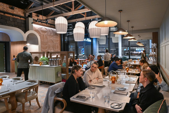 Pale timber finishes and dusty pink upholstery soften the former prison canteen’s interior.