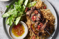 Vietnamese beef skewers with crispy noodles.