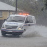 Two cops rescued after police car swept away in north Queensland floods