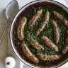 Sausages braised in red wine with herbs.