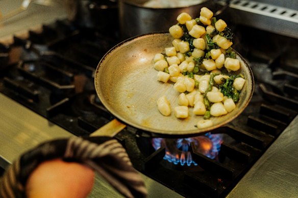 Pan-frying the gnocchi.