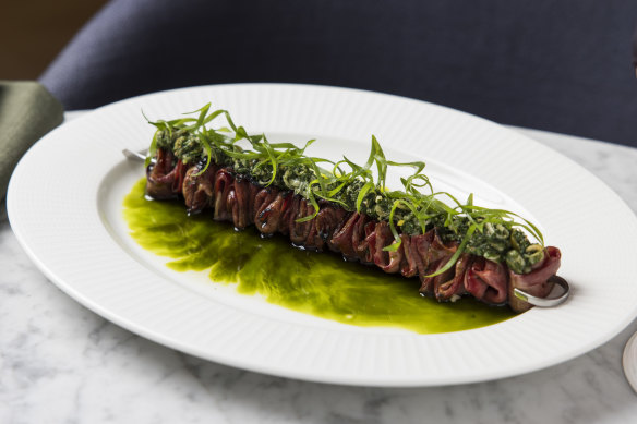 Robata-cooked skewers of beef tongue with spring onion and Sichuan pepper. 