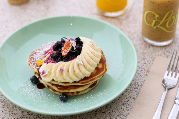 Cali pancake stack with banana, blueberries and maple syrup.