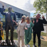 (L-R) Matt Gudinski, Jane Barnes, Sue Gudinski, Kate Gudinski and Jimmy Barnes pose for a photo at the unveiling of a life-sized statue of the late Michael Gudinski AM outside Rod Laver Arena.


