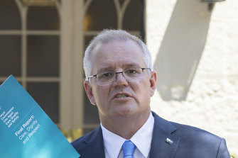 Prime Minister Scott Morrison with the Royal Commission Report into Aged Care. The government’s interim response is a $452 million package to address immediate safety and training issues raised by the report.