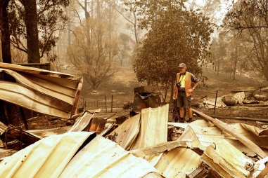 Sarsfield resident Wayne Johnston inspects damage to his property on Friday.