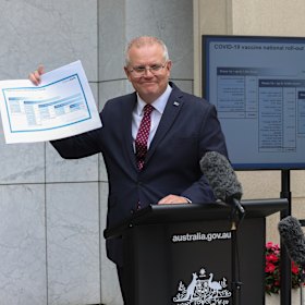 Scott Morrison  shows off the COVID-19 vaccine road map in January.