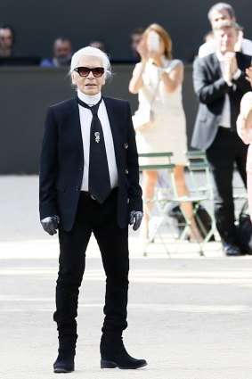 Karl Lagerfeld acknowledges applause after the presentation of Chanel's Haute Couture Fall/Winter 2017/2018 fashion collection, in Paris.