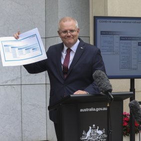 Scott Morrison  shows off the COVID-19 vaccine road map in January.