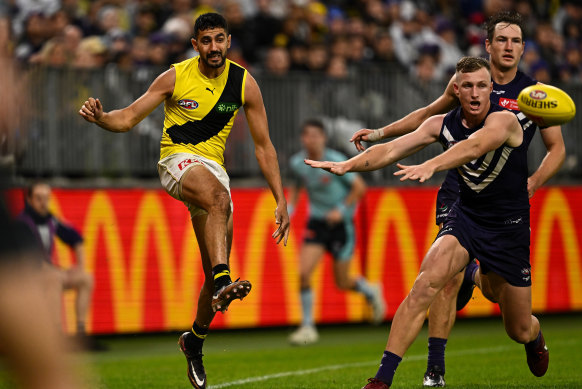 Marlion Pickett kicks the ball into play during Richmond’s clash against the Dockers in Perth on Saturday.