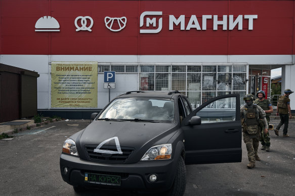 Ukrainian soldiers are seen outside a shop in Sudzha, Russia. Early this month, Ukrainian forces made a surprise incursion into Russia’s Kursk region from where Russia has been forced to evacuate more than 130,000 people. 