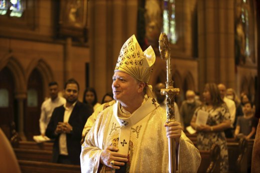 The Catholic Archbishop of Sydney, Anthony Fisher, oversees the Solemn Mass service before a smaller-than-usual congregation at St Mary's Cathedral.