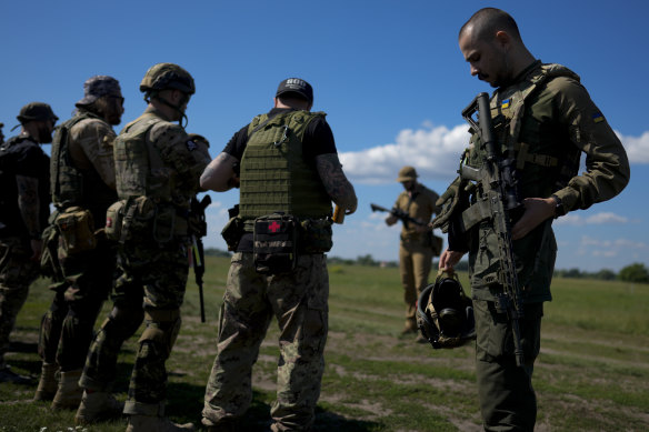 Rapper Otoy (right) attends a training sessionon the outskirts Kyiv, Ukraine, on June 7.