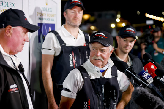 John Winning snr with his son John jnr (background) after Andoo Comanche took 2022 Sydney to Hobart line honours.