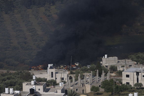 Smoke fills the sky after Israeli settlers set  fire to the properties of Palestinian villagers in the West Bank village of al-Mughayyir.