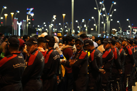 Police stand in line to limit the number of people entering the fan zone.