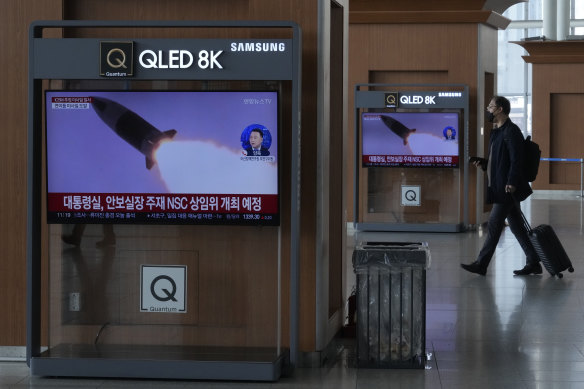 TV screens show a file image of North Korea’s missile launch on a news program in Seoul, South Korea, on Friday.