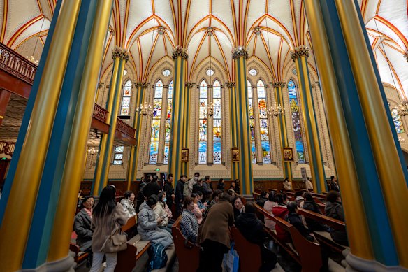 Parishioners get ready for mass at the Xishiku Church in Beijing.