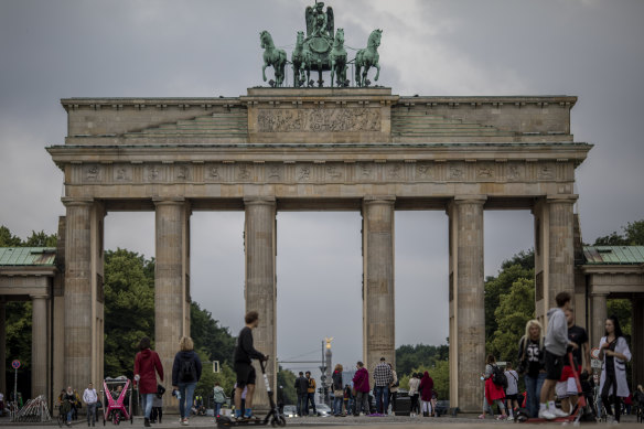 Tourists walk past Brandenburg Gate in Berlin, Germany. Travel restrictions are easing, but look set to be increased for visitors from the United States. 