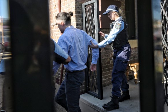 Tyrell Edwards is led away by police after pleading guilty and being denied bail.