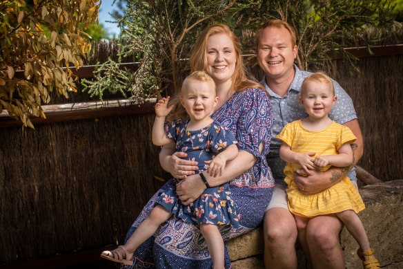 Andrew and Alana Spencer and their two-year-old twins Aurora (in yellow) and Bexley (in blue) 