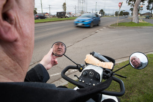 Garry Clancy, who relies on a mobility scooter, can't cross Ballarat Road. He and his neighbour David Richardson (right) are among dozens of residents calling for pedestrian crossings.