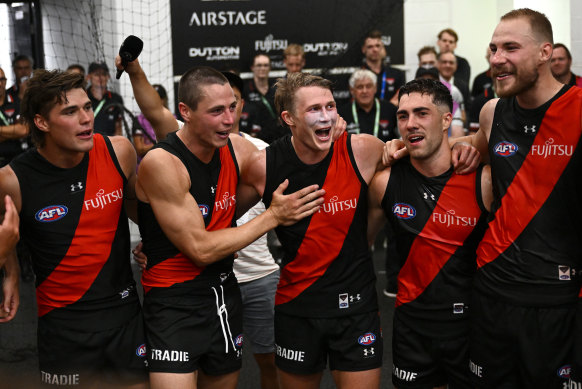 Sam Durham, Jake Kelly , Xavier Duursma, Jade Gresham and Ben McKay of the Bombers sing the song.