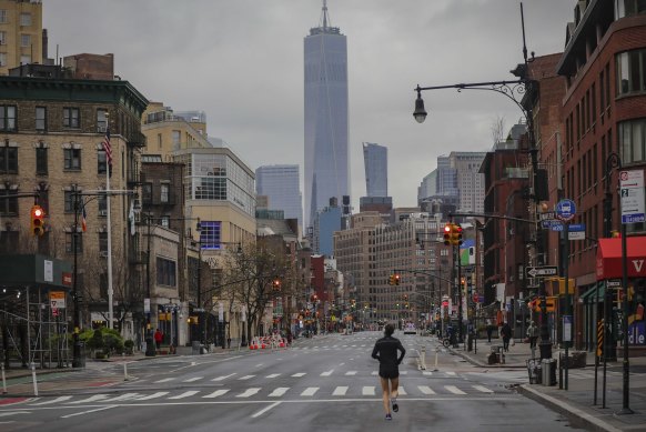 A lone jogger runs on a partially empty 7th Avenue in New York last week.