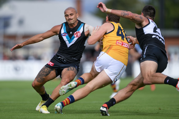 Powell-Pepper prepares to tackle Mark Keane.