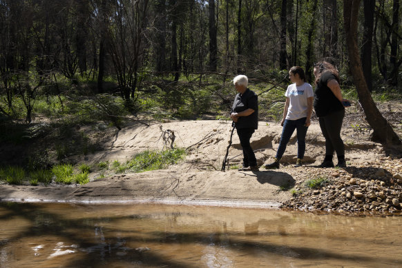 Traditional Owners Kazan Brown, Taylor Clarke and Aunty Sharyn Halls at a water hole on the site.
