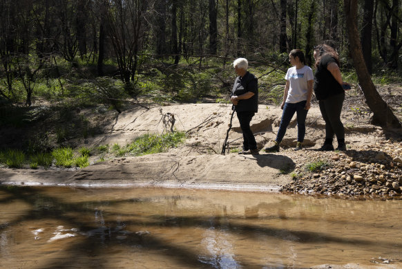 Traditional owners Kazan Brown, Taylor Clarke and Aunty Sharyn Halls at a water hole on the site.