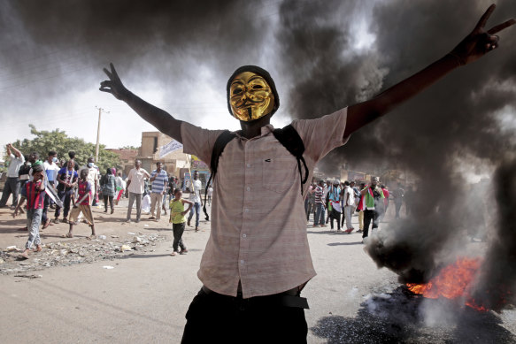 A man flashes the victory sign during a protest to denounce the October 2021 military coup, in Khartoum, Sudan in January. 