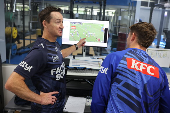 Toby Sexton and Jason Taylor work through a video session at Belmore Oval.