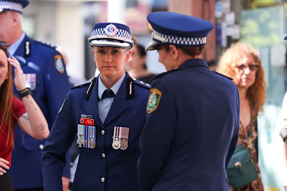 NSW Police Inspector Amy Scott (centre) speaks to NSW Police Commissioner Karen Webb.