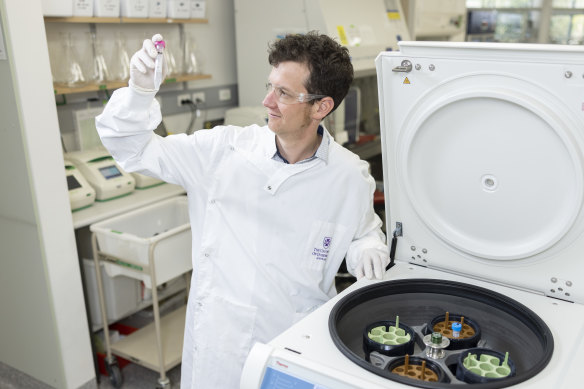 Dr Keith Chappell in the lab with a sample of the new vaccine developed with Clamp 2.0
