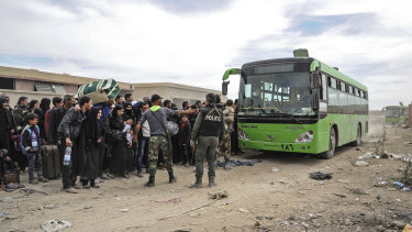 This photo from the Syria's official news agency shows residents leaving Hamouria in eastern Ghouta, a suburb of Damascus.