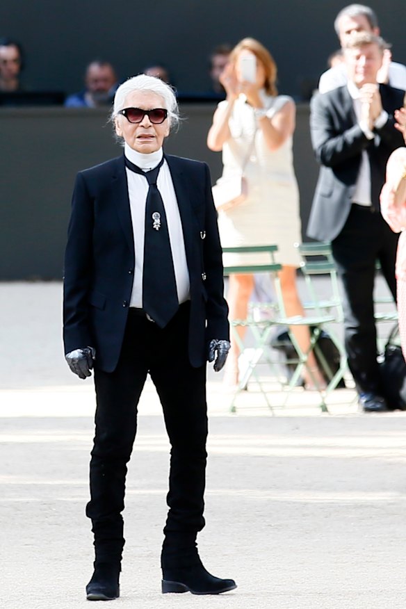 Karl Lagerfeld acknowledges applause after the presentation of Chanel's Haute Couture Fall/Winter 2017/2018 fashion collection, in Paris.