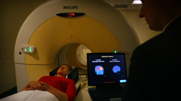 An Alzheimer's patient undergoes a scan as Professor Christopher Rowe of Melbourne University looks on.