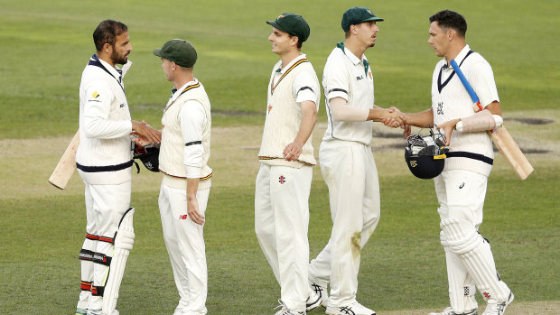 Too good: Fawad Ahmed of Victoria (left) and Scott Boland of Victoria (right) congratulate Tasmanian players on their round 10 JLT series win at Blundstone Arena in Hobart