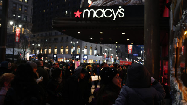 Pedestrians pass in front of a Macy's Inc. department store in New York.