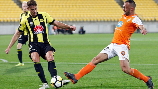 Ivan Franjic of the Brisbane Roar (right) stretches out to stop a kick from Dylan Fox of the Phoenix during the round 24 match at Westpac Stadium in Wellington, New Zealand, on Sunday.