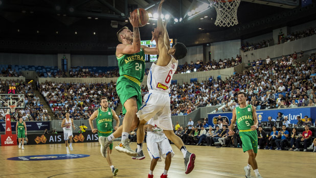 Australia's Mitch Creek drives against Philippines guard Kevin Alas on Thursday night.