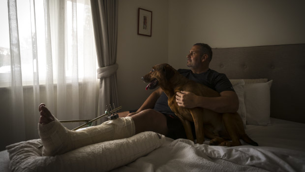 Mike Gill, who was left for dead after he was hit by a car in Coburg on New Year's Eve, with his dog Bastien.