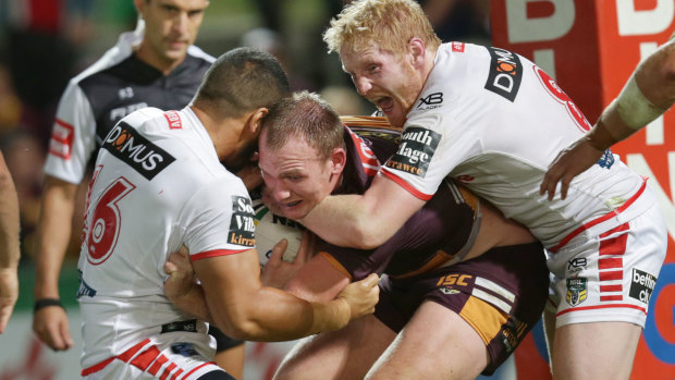 Long night: Matt Lodge gets hammered by the Dragons forwards. 