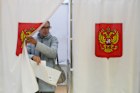 A voter leaves a voting booth during the parliamentary election in Podolsk, Moscow region, Russia, on Saturday.