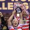 Liam Farrell of Wigan Warriors lift the trophy following victory.