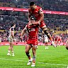 The Dolphins celebrate a Kodi Nikorima try.