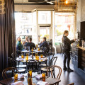 Dark walls and light fixtures made from fencing wire create a masculine aesthetic at La Luna.