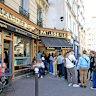 Visitors queue at a patisserie in Paris featured on the Netflix series Emily in Paris.