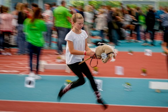 A participant competes in the dressage event at the first German Hobby Horsing Championship in Frankfurt, Germany.